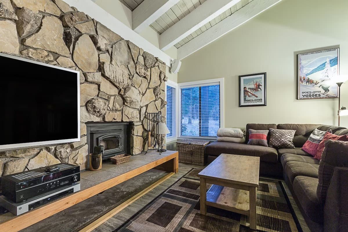 Great room with stone fireplace and ski posters