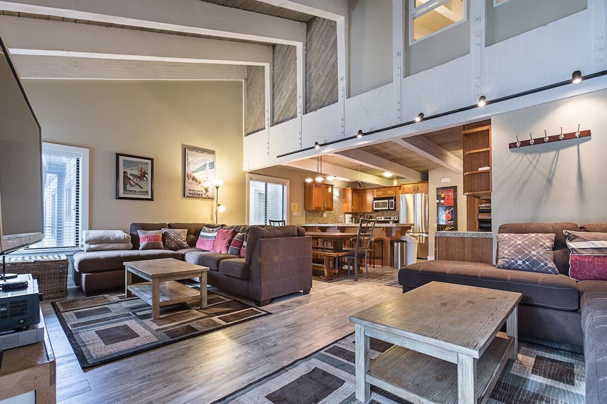 Open living room with vaulted ceilings and loft